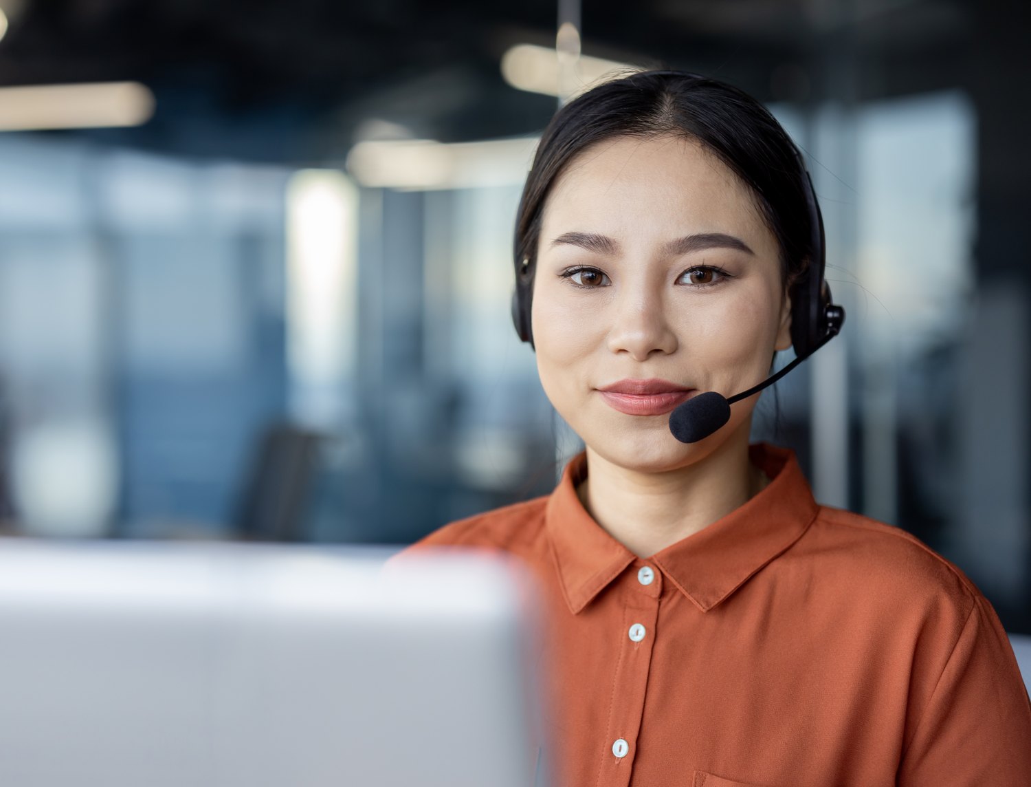 Support agent on a headset in an open plan office
