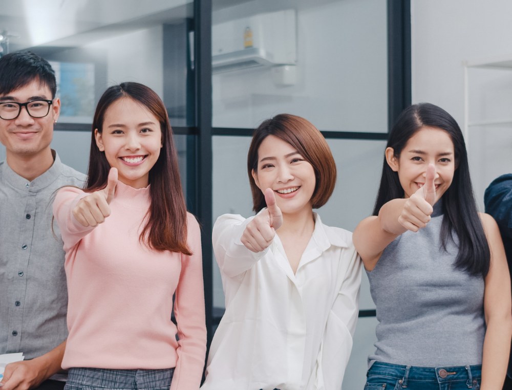 Support team standing together in an office