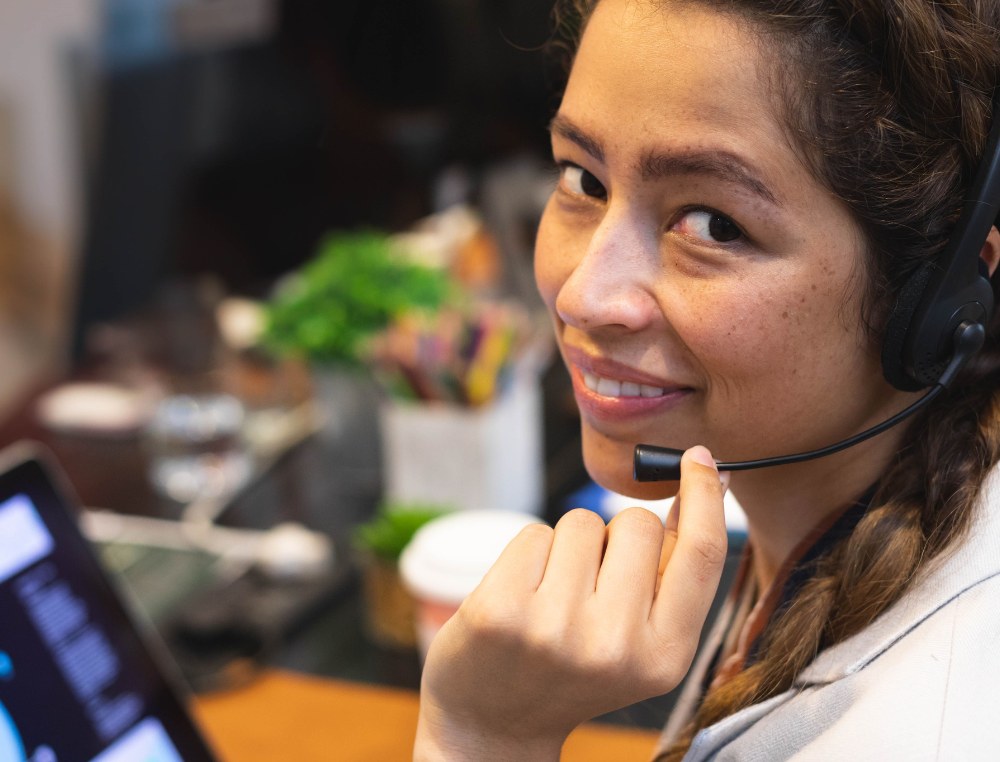 Support agent on a headset call at her desk