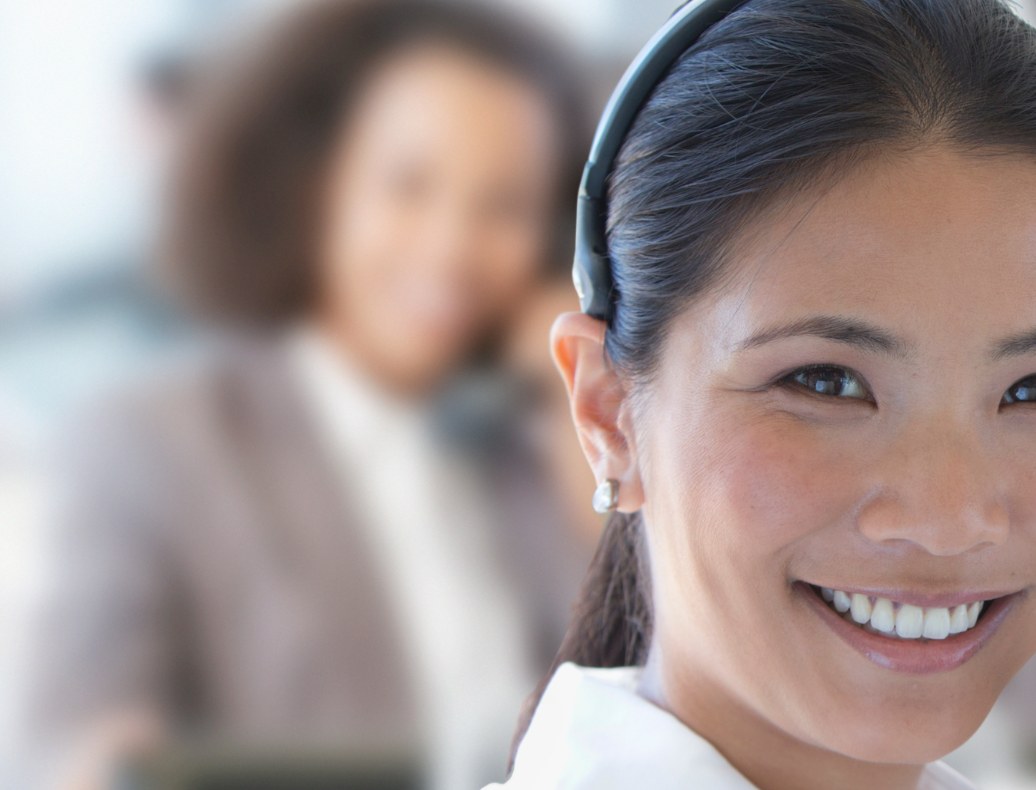 Support agent smiling during a customer call