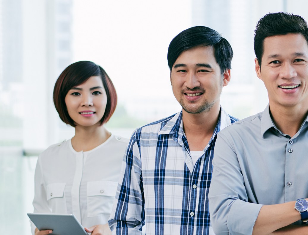 Office team standing together by a window