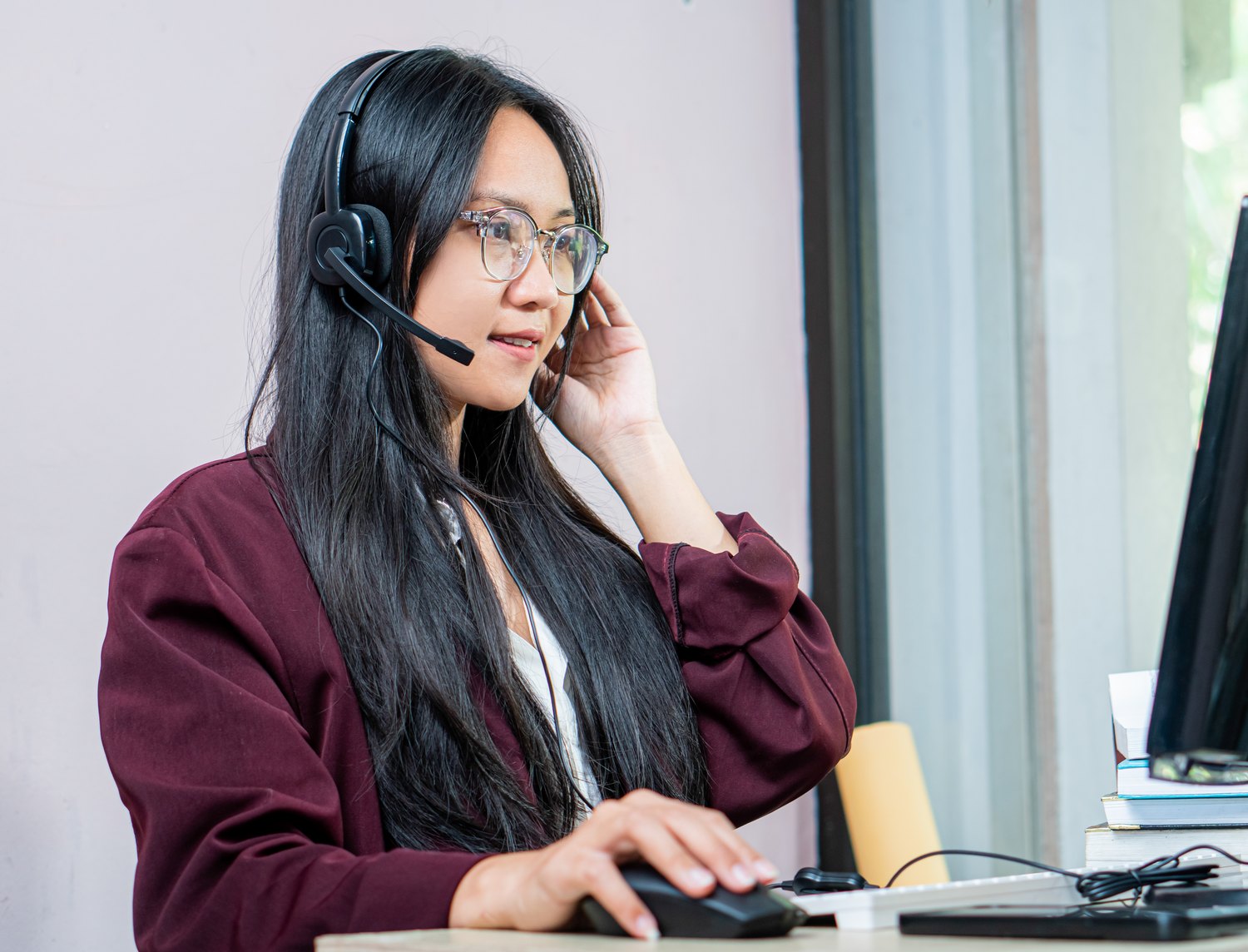 Agent on a headset at a dual screen desk