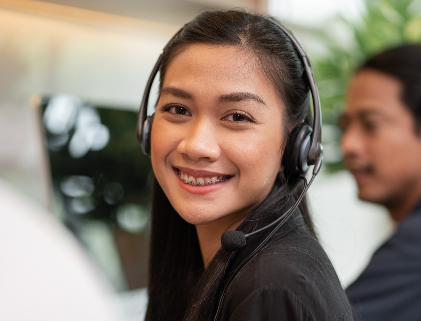 Agent on a headset call in an open plan office