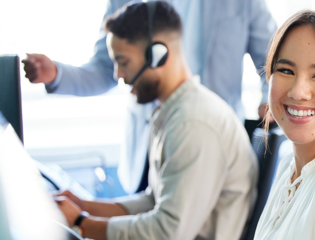 Agent taking a call while a colleague works behind
