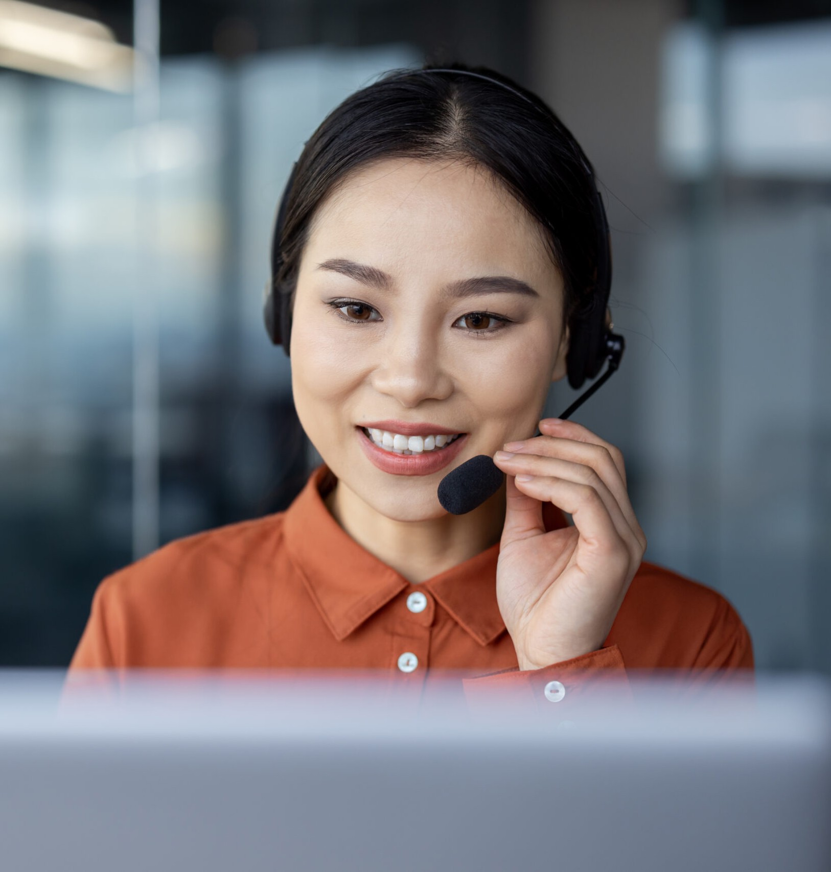 Support agent on a call at her desk in the Dumaguete office