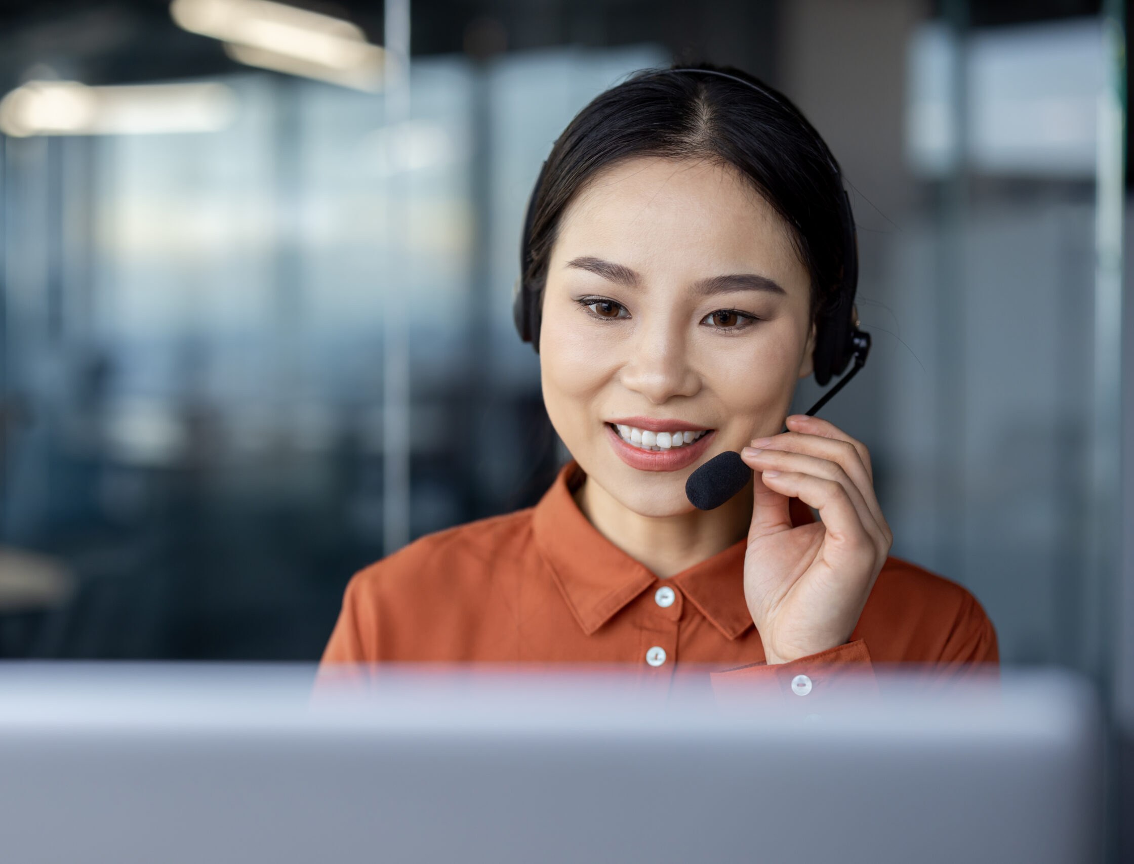 Support agent on a call at her desk