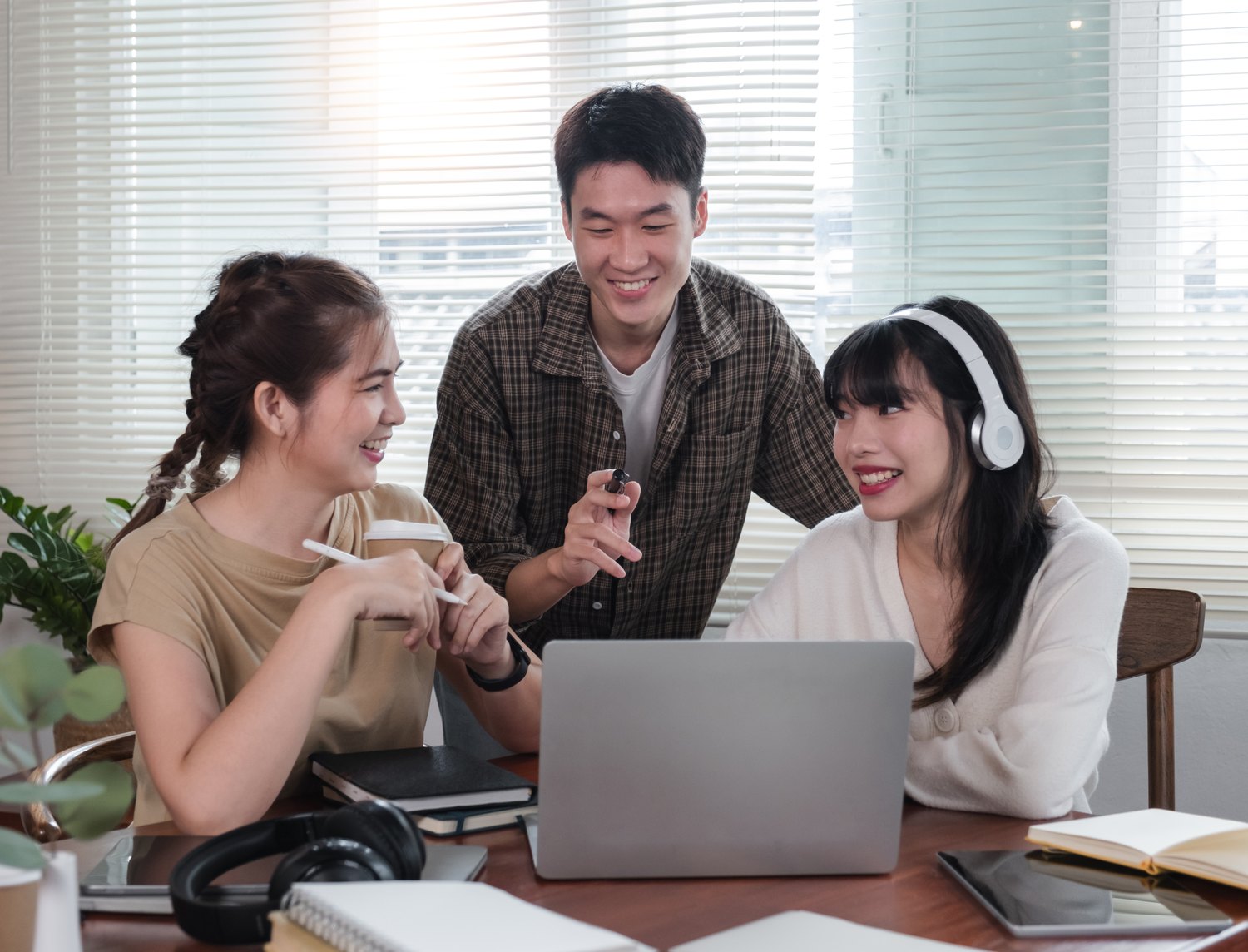 Team reviewing an account together on a laptop