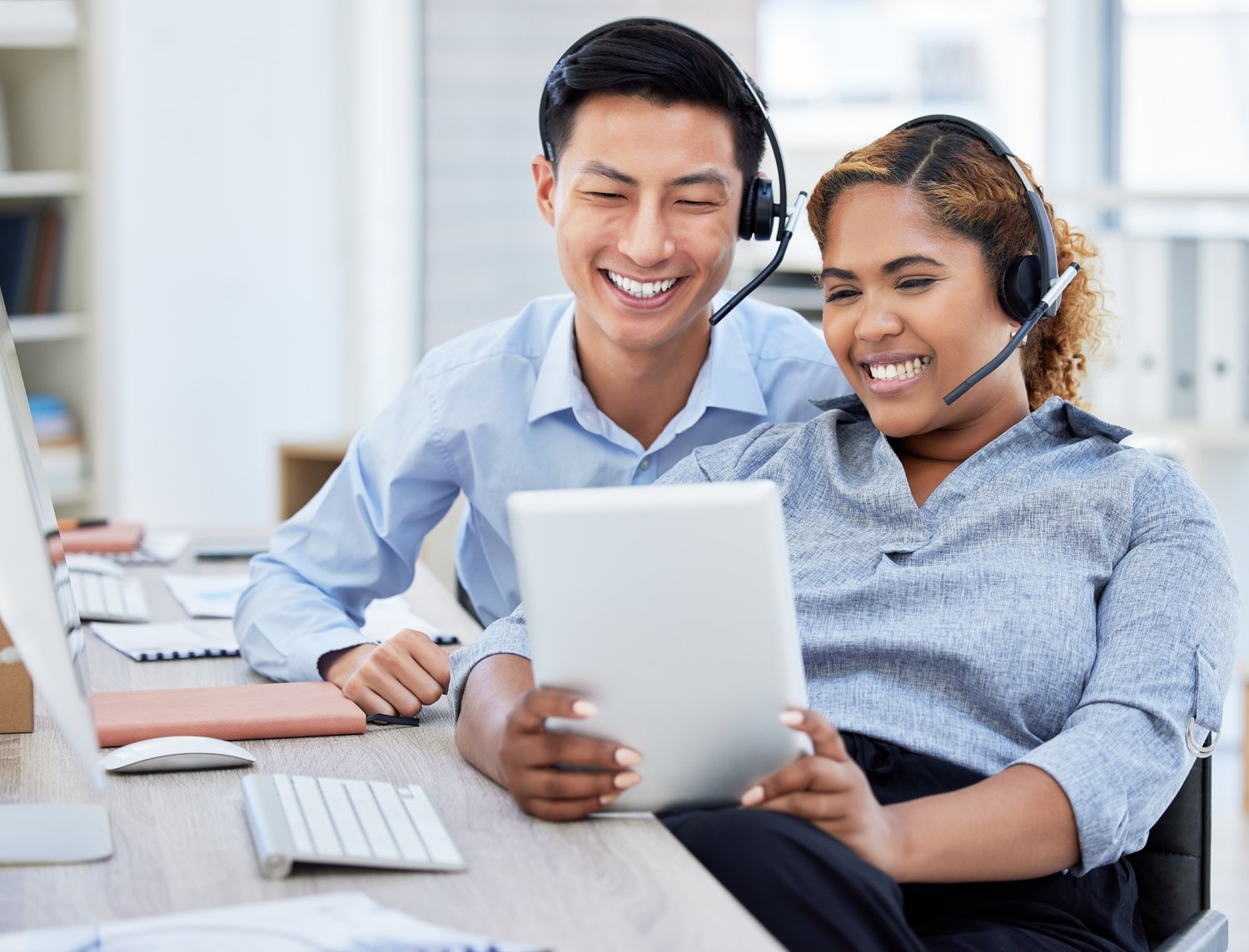 Colleagues sharing a result at their desks